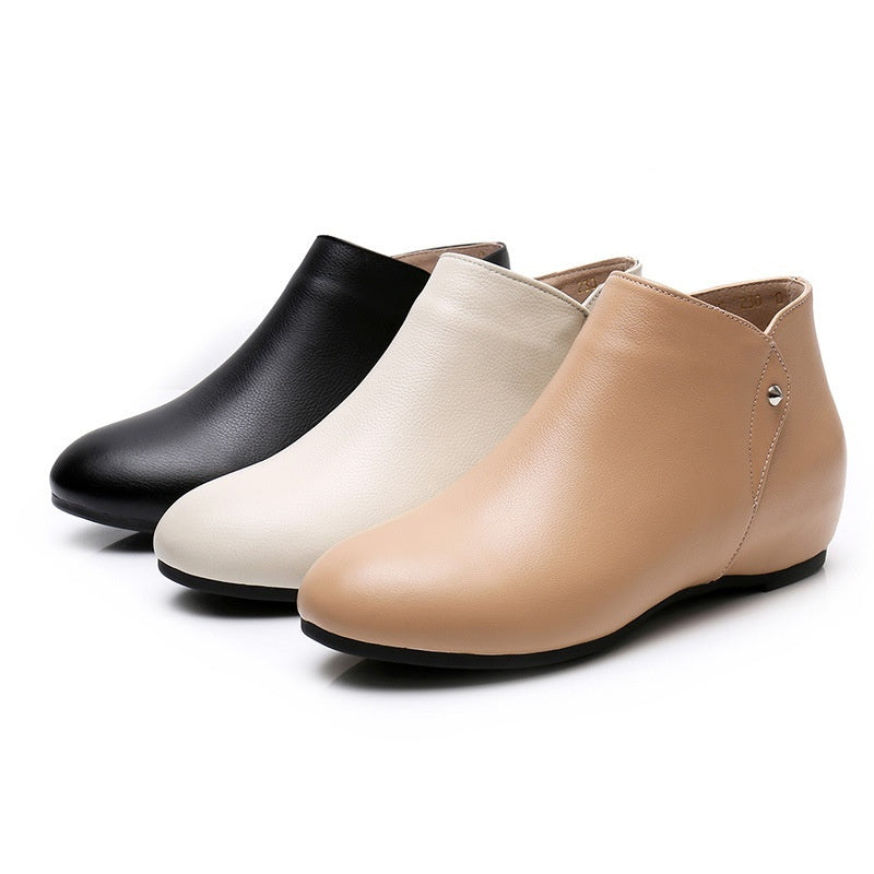 Three pairs of ankle boots in black, white, and beige on a white background