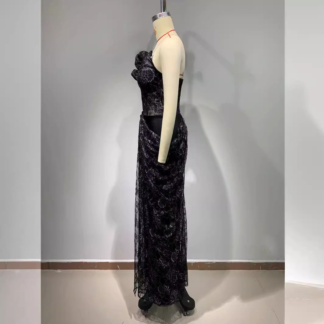 Black floral-patterned evening gown on a mannequin against a plain background
