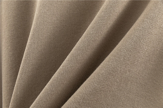 Close-up of beige fabric with a textured pattern