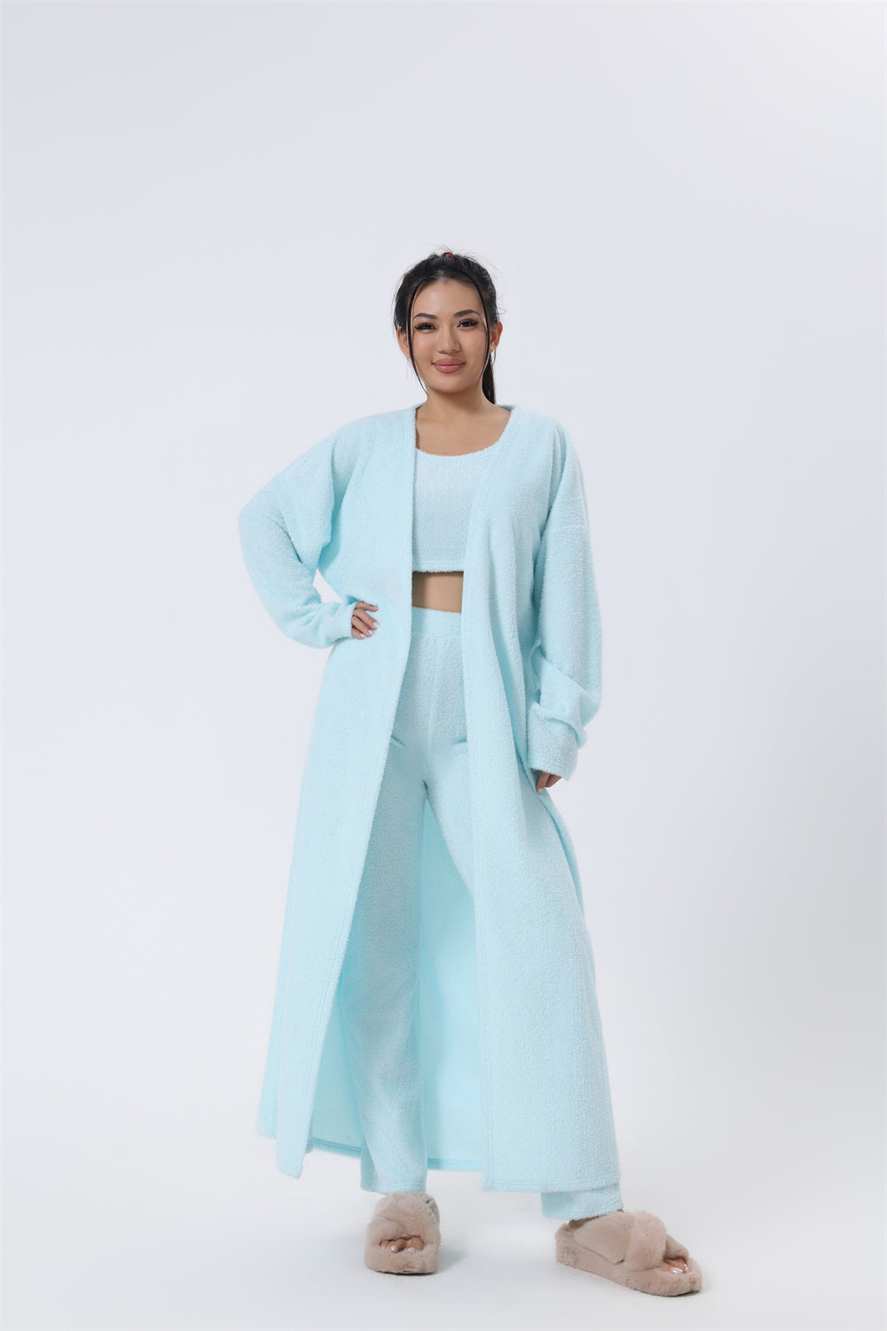 Person wearing a light blue outfit on a white background
