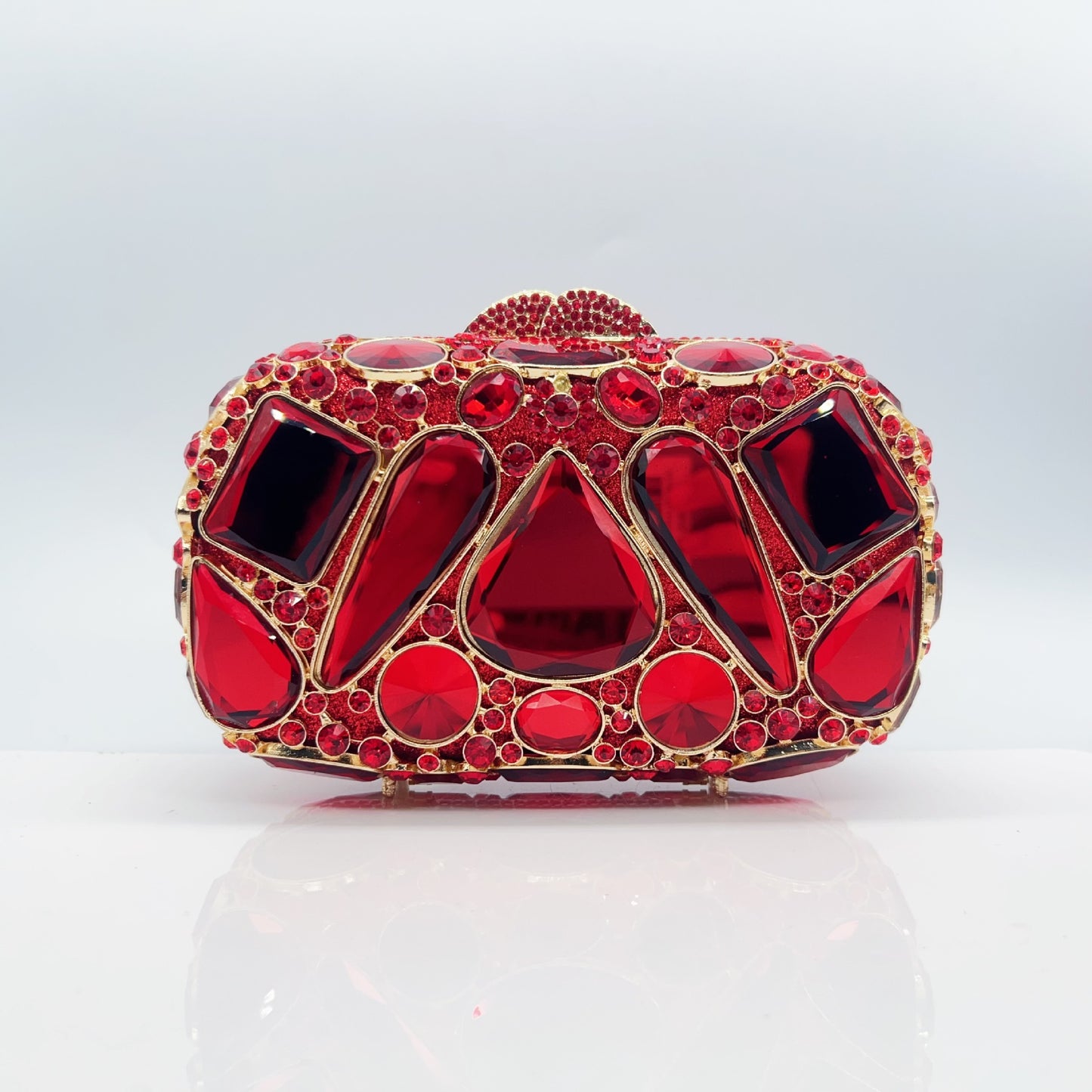 Red gemstone-encrusted clutch bag on a white background