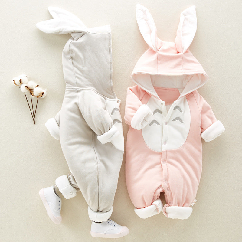 Two baby rompers with bunny ears, one gray and one pink, on a light background.