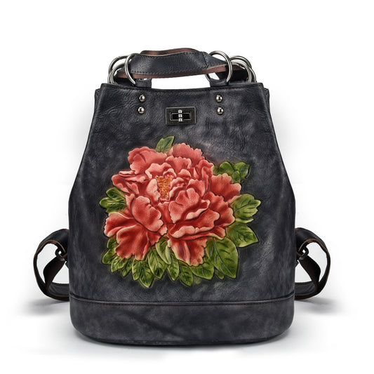 Black backpack with a large pink floral design on a white background