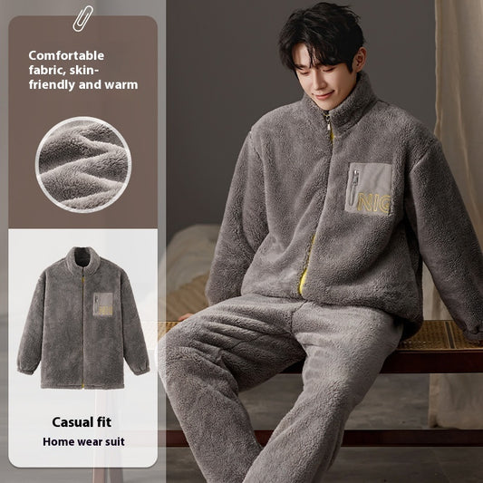 Person wearing a gray home wear suit with NIC branding, sitting on a bed.