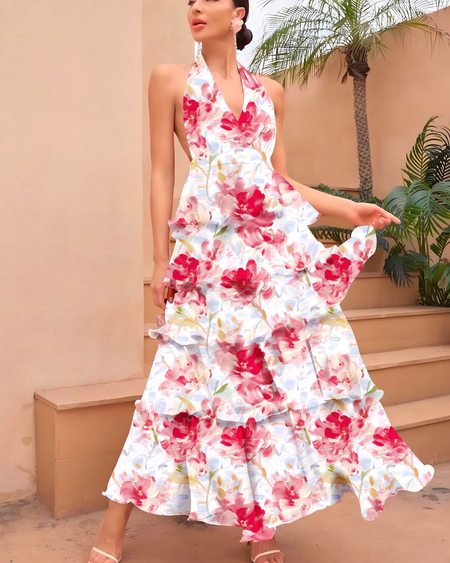 Woman wearing a floral dress standing outdoors with plants and steps in the background