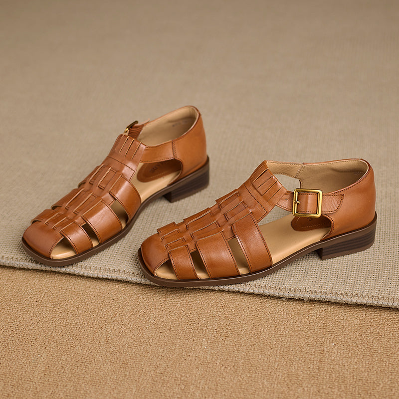 Pair of brown sandals with woven design on a beige background