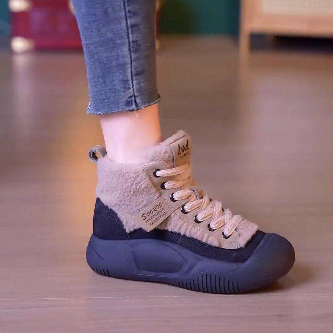 Beige and navy winter sneaker on a blurred indoor floor background
