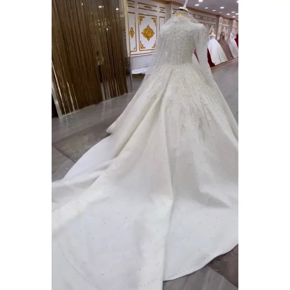 The Traîne Long Sleeve Bridal Gown