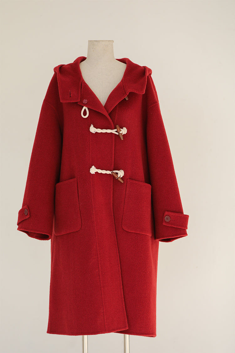 Red coat on a mannequin against a white background
