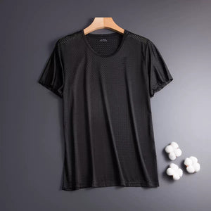 Black t-shirt on a hanger with cotton balls on a gray background