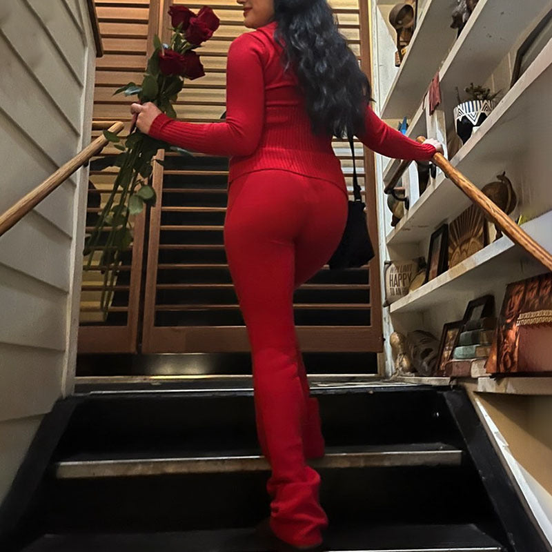 Person in a red outfit holding flowers on a staircase. by millivan