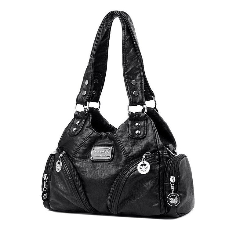 Black handbag with multiple zippers and a visible brand logo on a white background