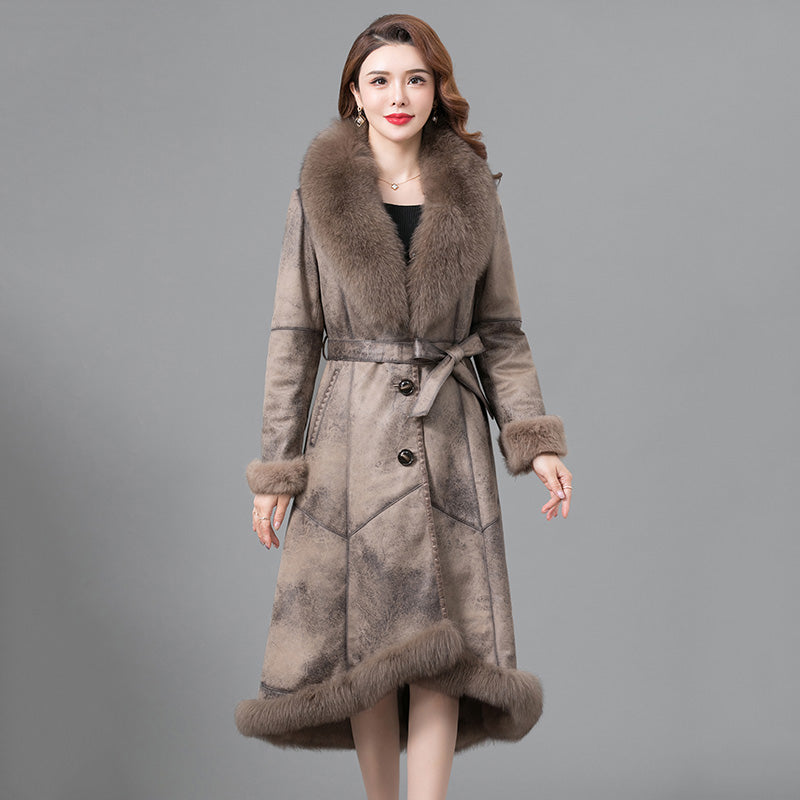 Woman wearing a long fur coat with a gray background