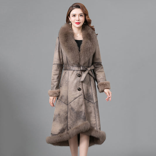 Woman wearing a long fur coat with a gray background