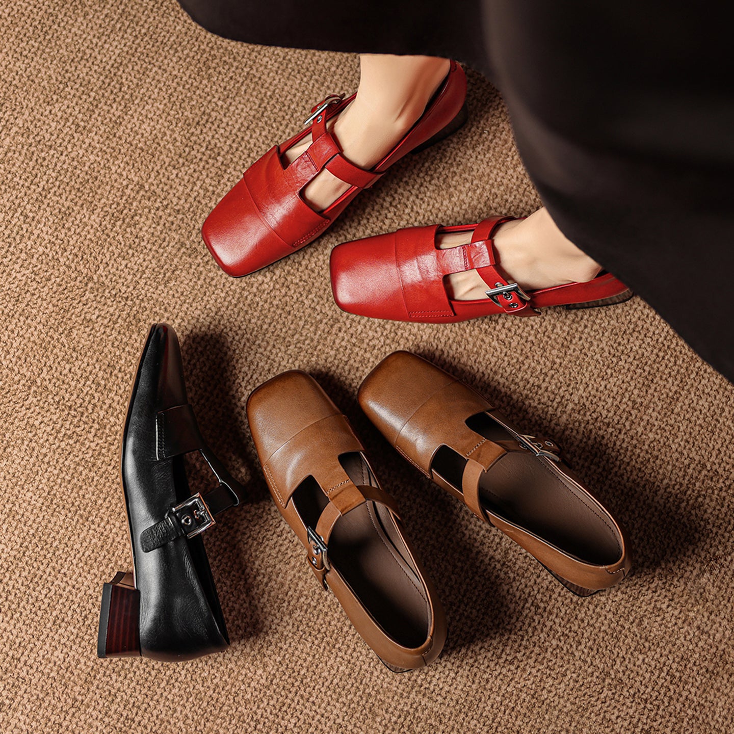 Red, brown, and black shoes on a textured surface