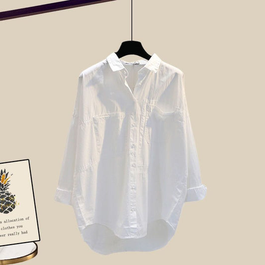White shirt on a hanger against a beige background