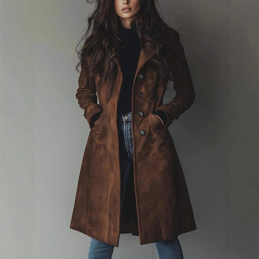 Woman wearing a brown coat against a plain background