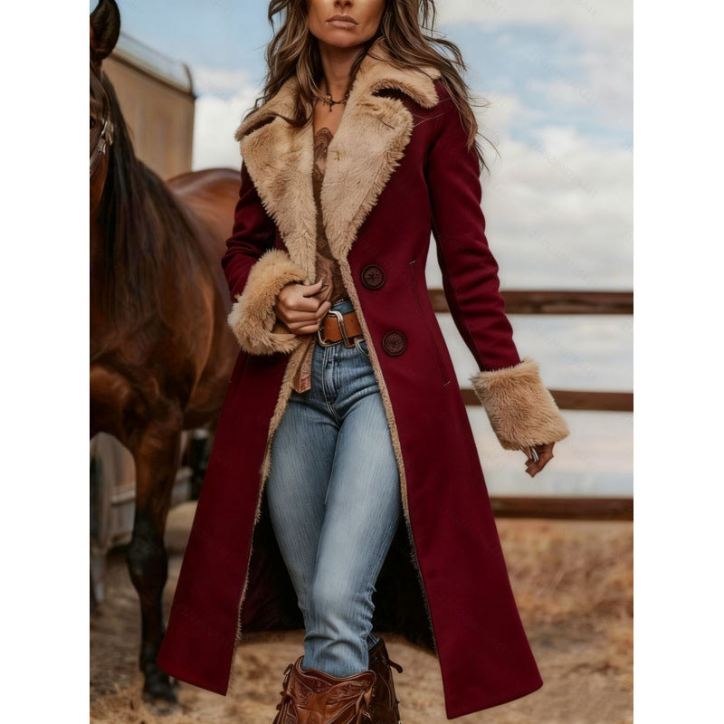 A woman wearing a long burgundy wool-blend coat with a beige shearling-style collar and matching faux-fur trimmed cuffs, standing outdoors beside a horse in a rustic setting.