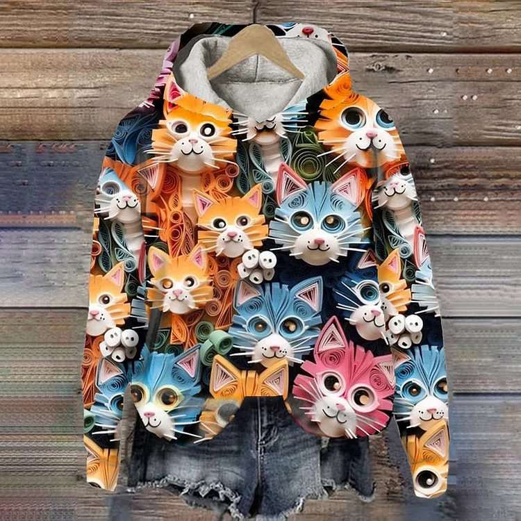 Colorful hoodie with cat-themed design on a wooden background