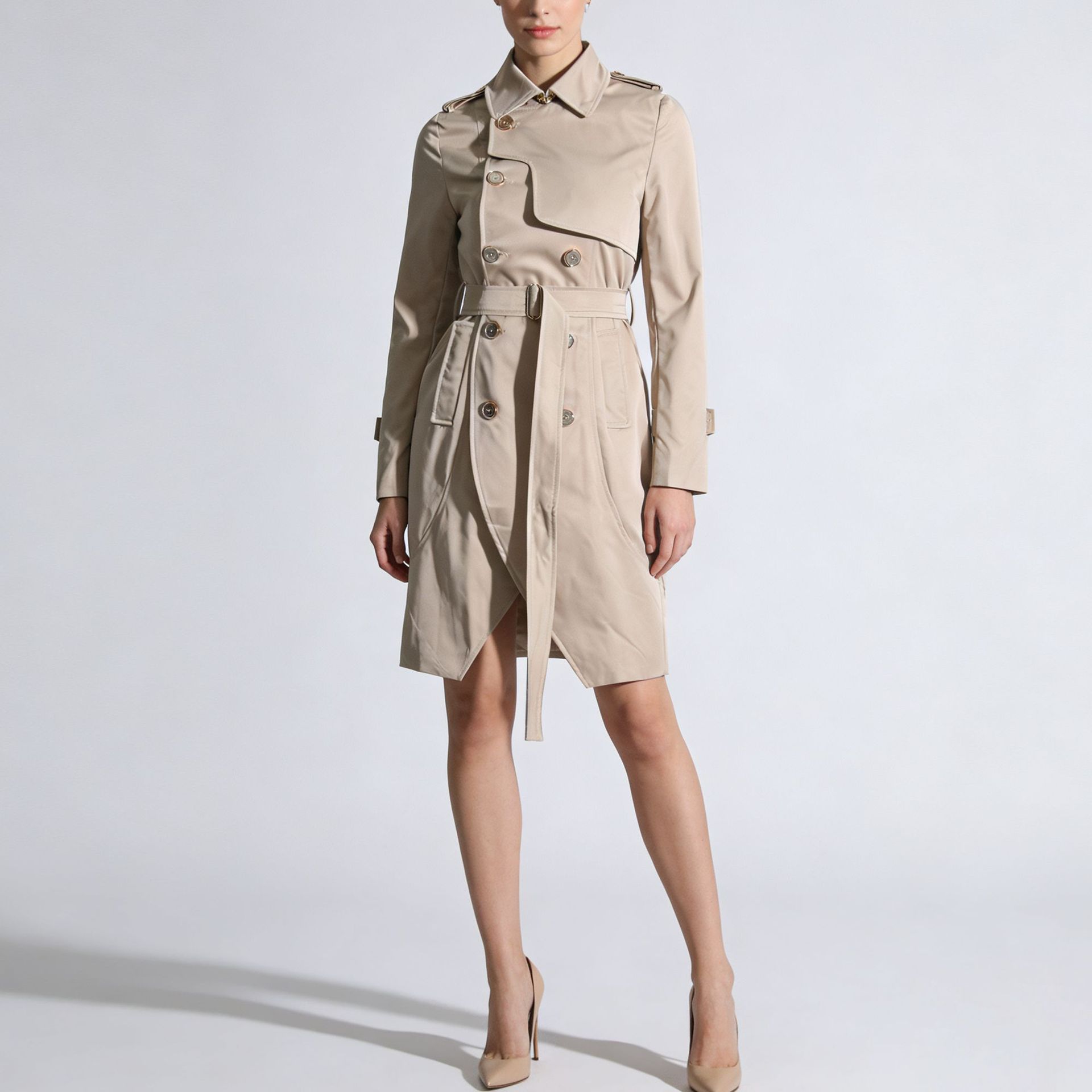 Beige trench coat worn by a model on a white background by millivan