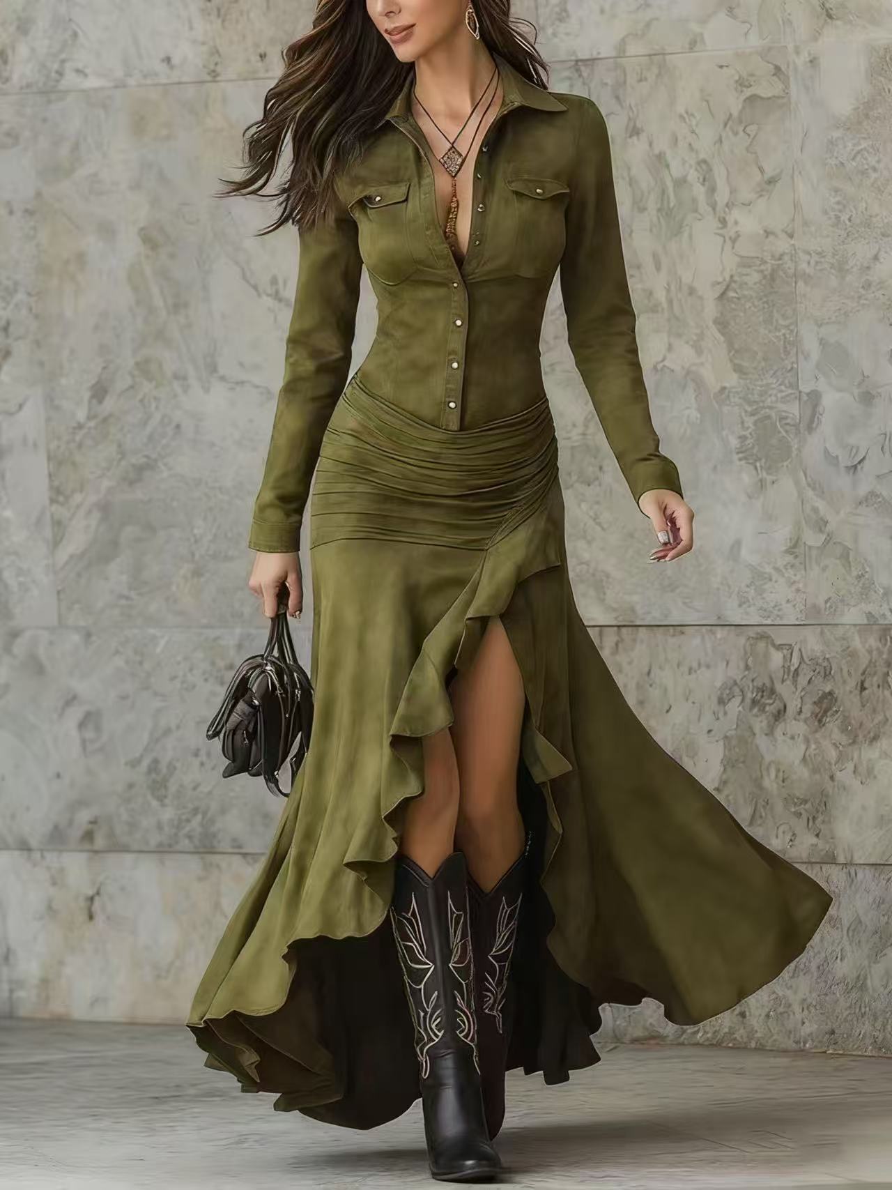 Woman wearing an olive green dress with a high-low hem and black cowboy boots against a stone wall.