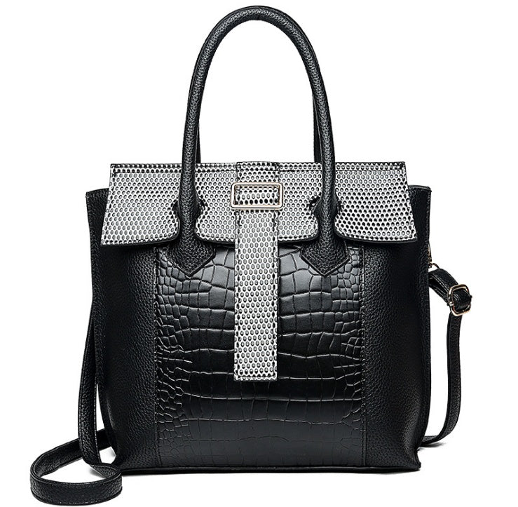Black handbag with silver mesh accents on a white background