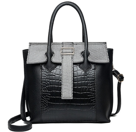 Black handbag with silver mesh accents on a white background