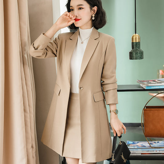 Woman wearing a beige coat in an indoor setting