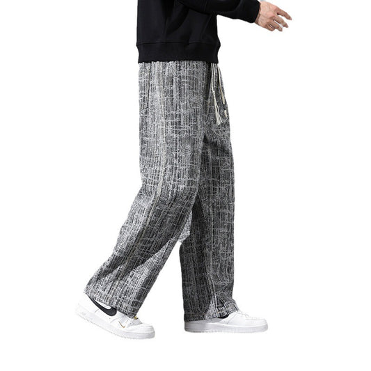 Person wearing black and white checkered pants on a white background