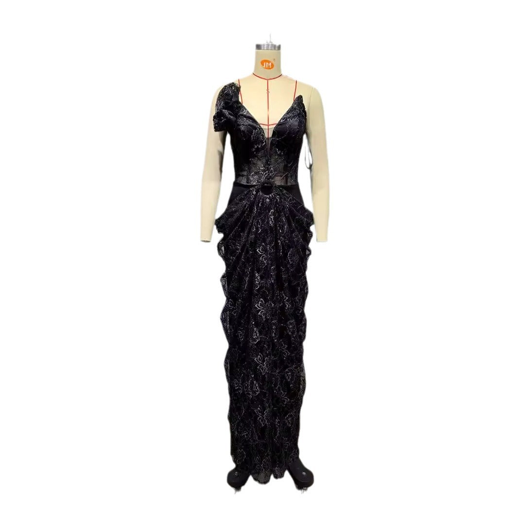Black evening gown on a mannequin against a white background