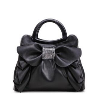 Black handbag with a large bow detail on a white background