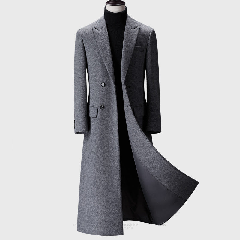 Gray overcoat on a mannequin against a white background