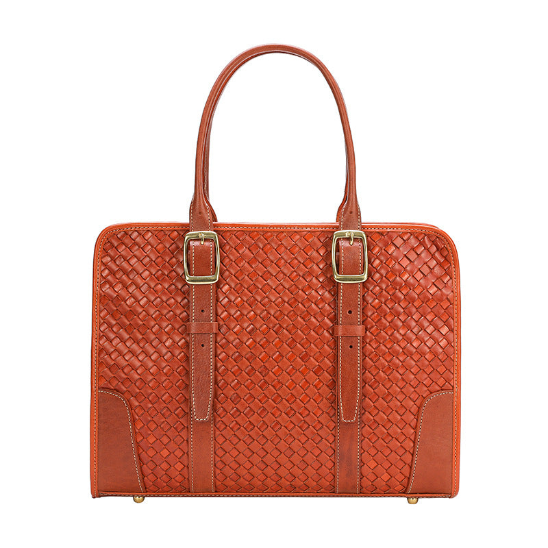 Brown woven handbag with gold buckles on a white background