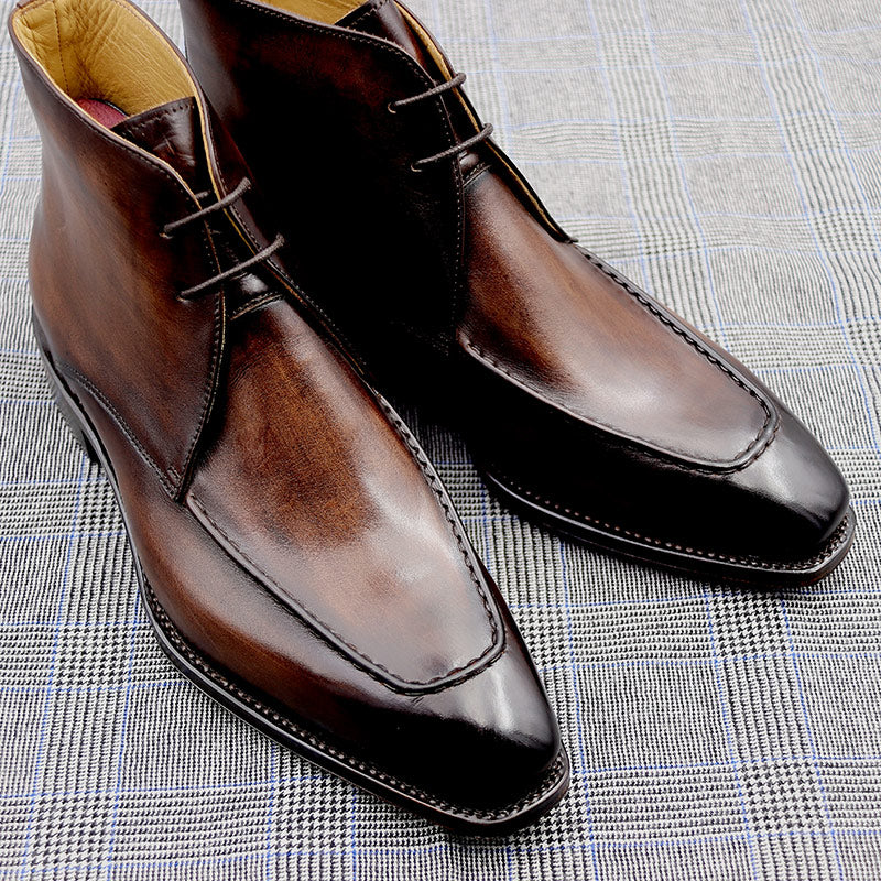 Pair of brown dress shoes on a textured fabric background