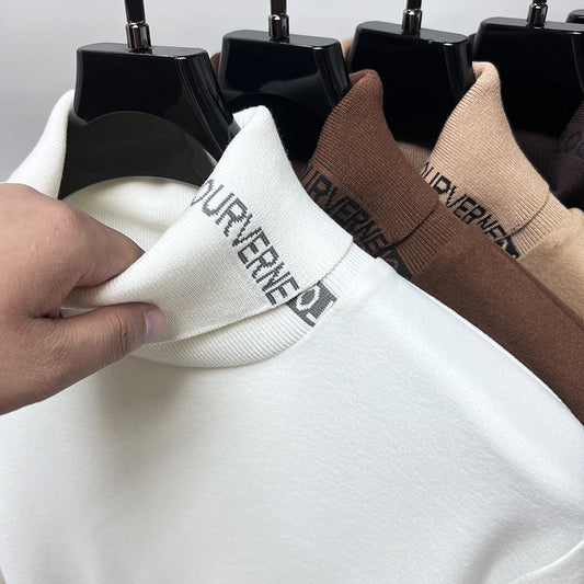 White sweater with brand logo being held, surrounded by other sweaters on hangers.