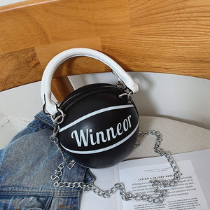 Black handbag with white handle and 'Winnenor' branding on a chair.