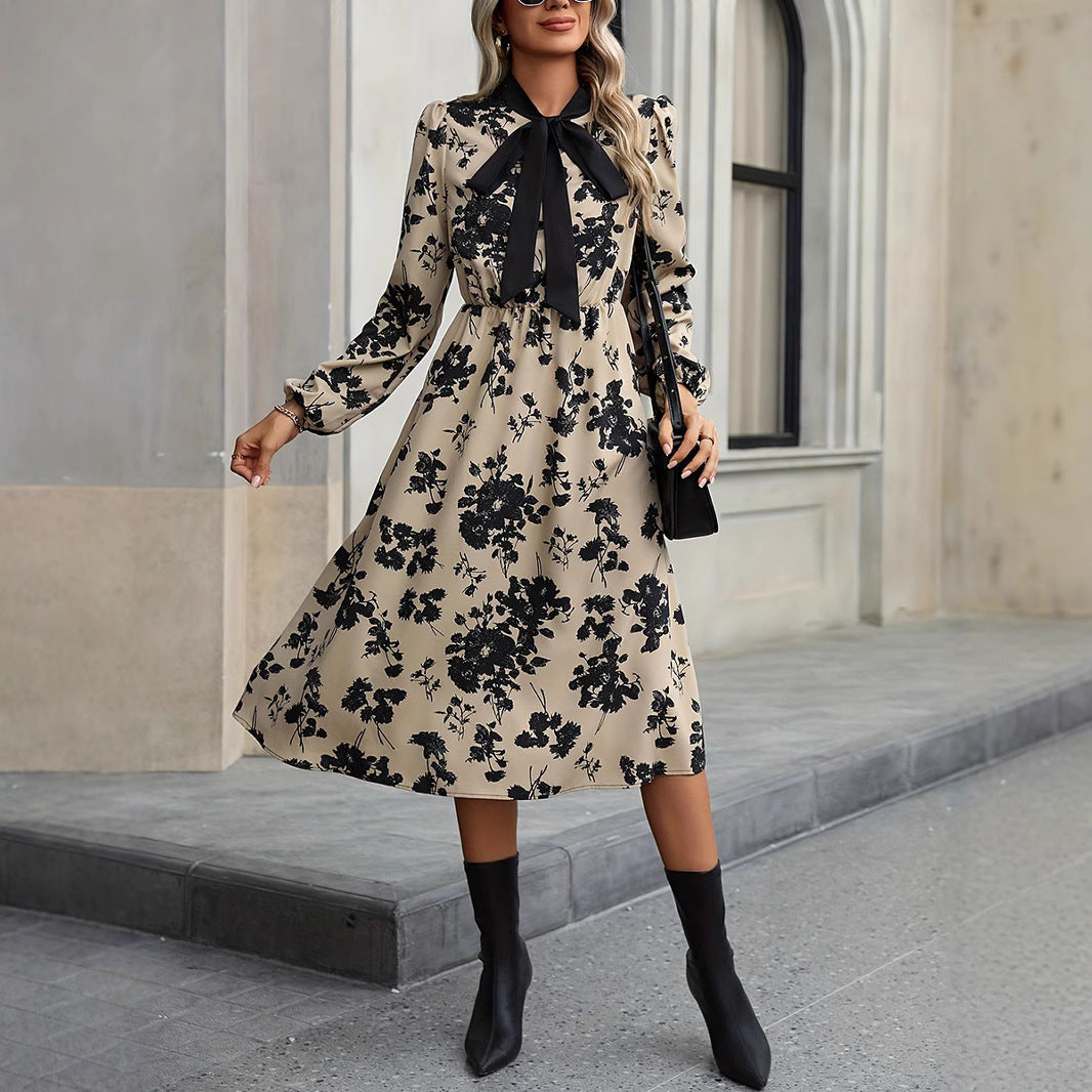 Woman wearing a floral dress with black accents in an urban setting