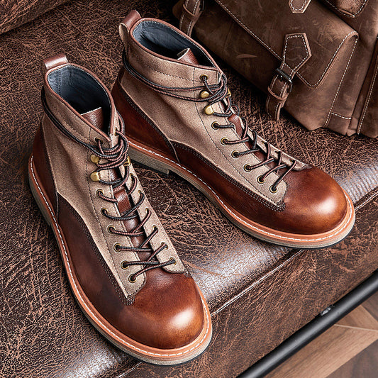 Pair of brown leather boots on a textured surface with a brown bag in the background.