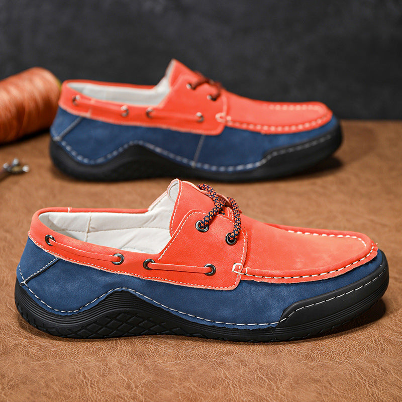 Red and blue loafers on a brown surface with a dark background