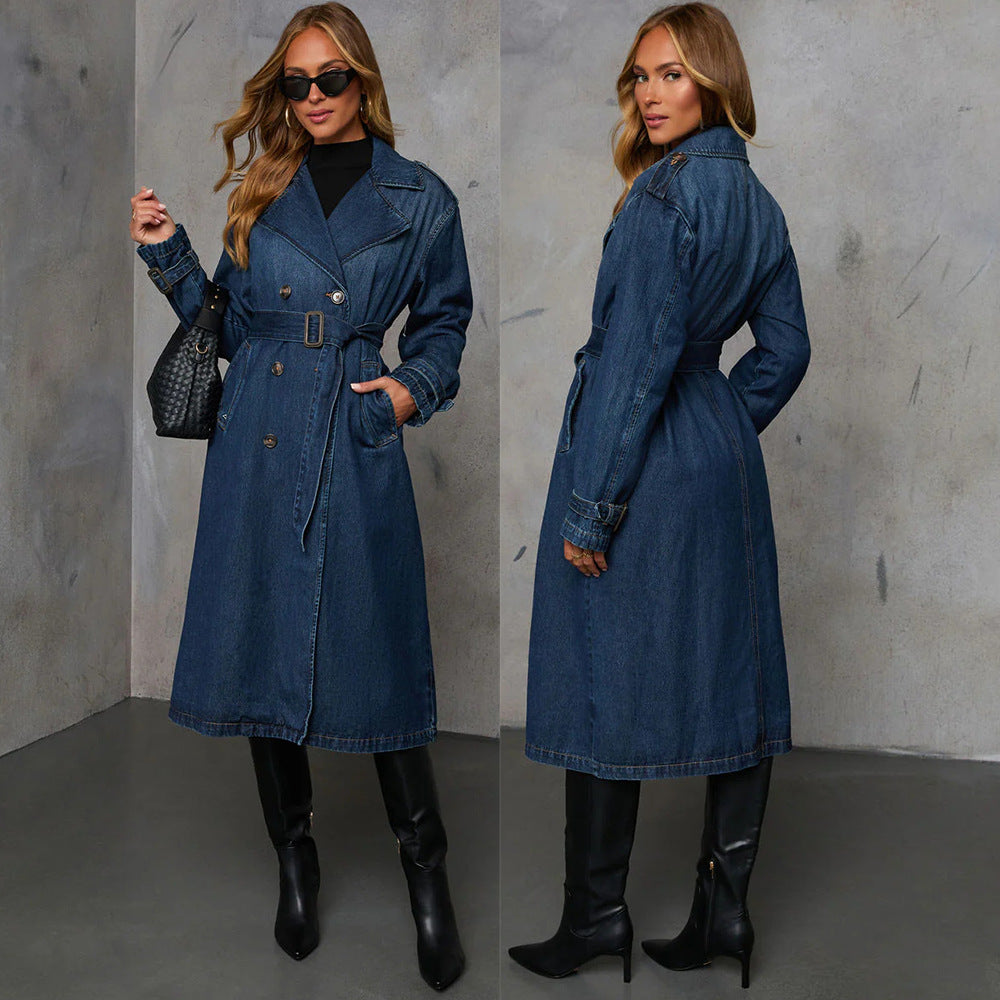 Woman wearing a blue denim coat and black boots against a gray background