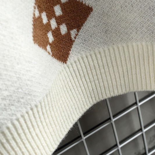 Close-up of a textured fabric with a checkered pattern on a tiled floor.
