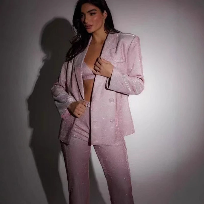 Woman wearing a sparkly pink suit against a plain background