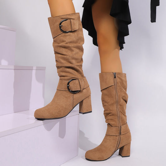 Tan knee-high boots with buckles on a white background