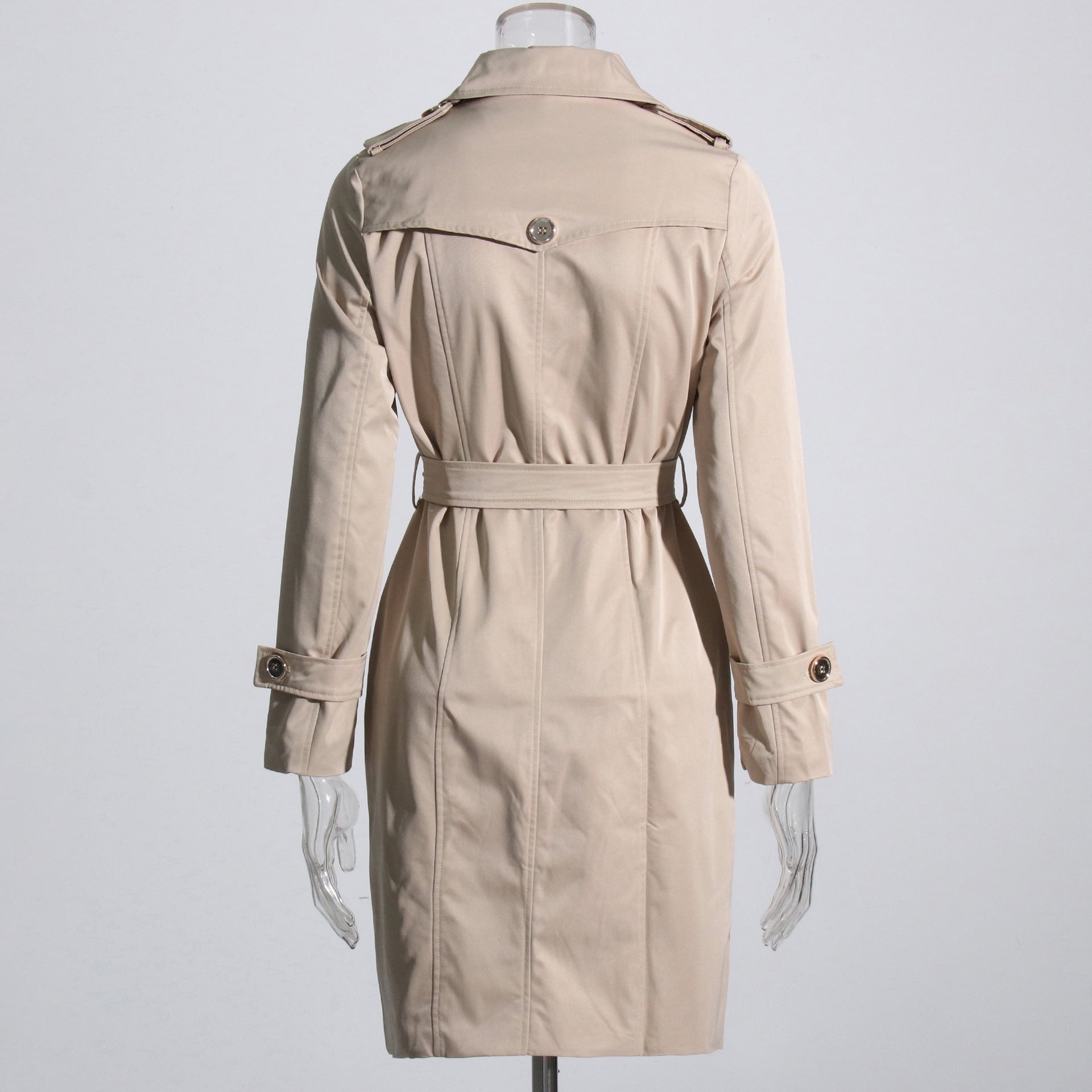 Beige trench coat on a mannequin against a light gray background by millivan