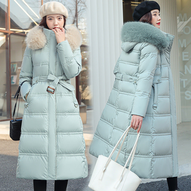Light blue puffer coat with fur hood worn by a model outdoors.
