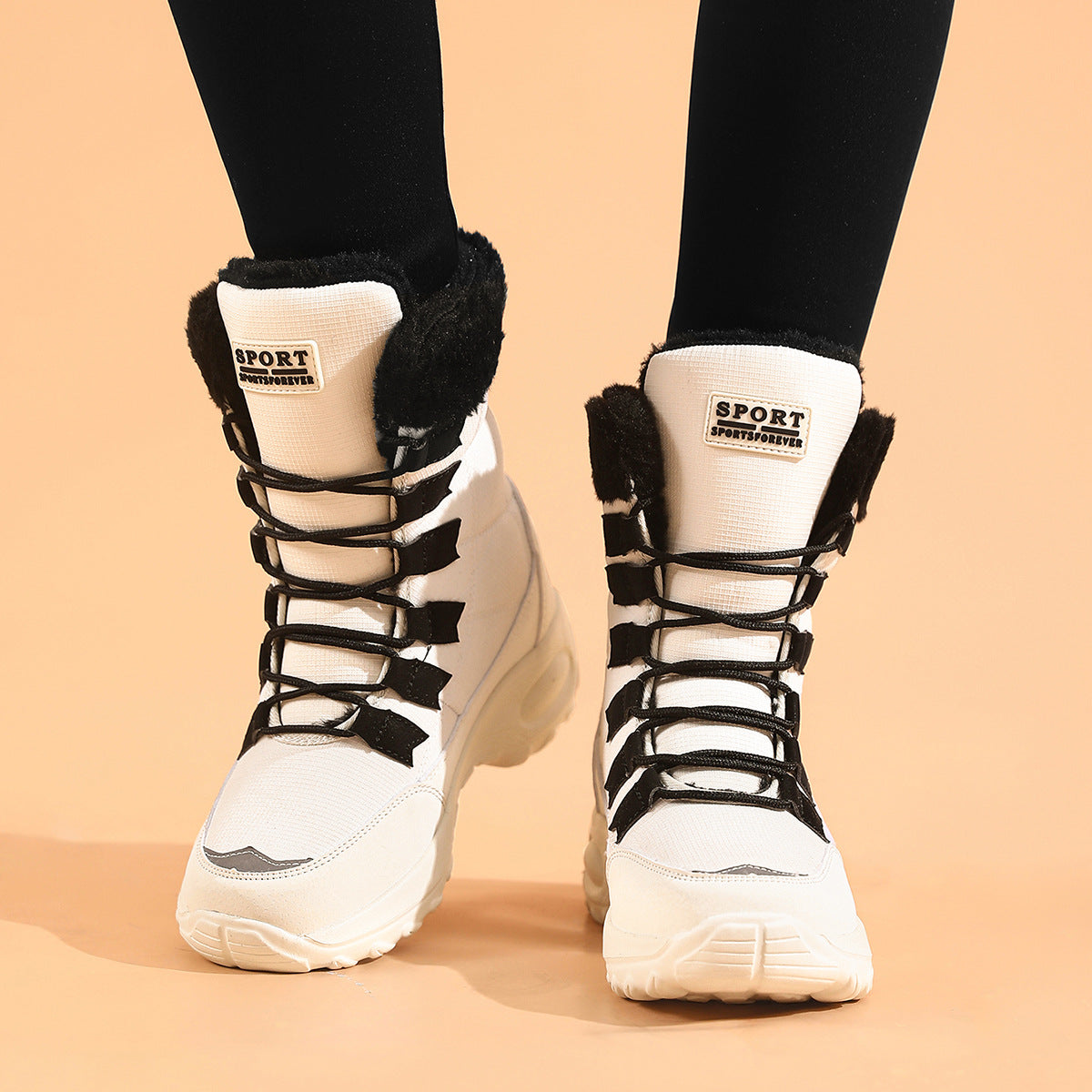 White high-top sneakers with black laces and fur lining on a beige background