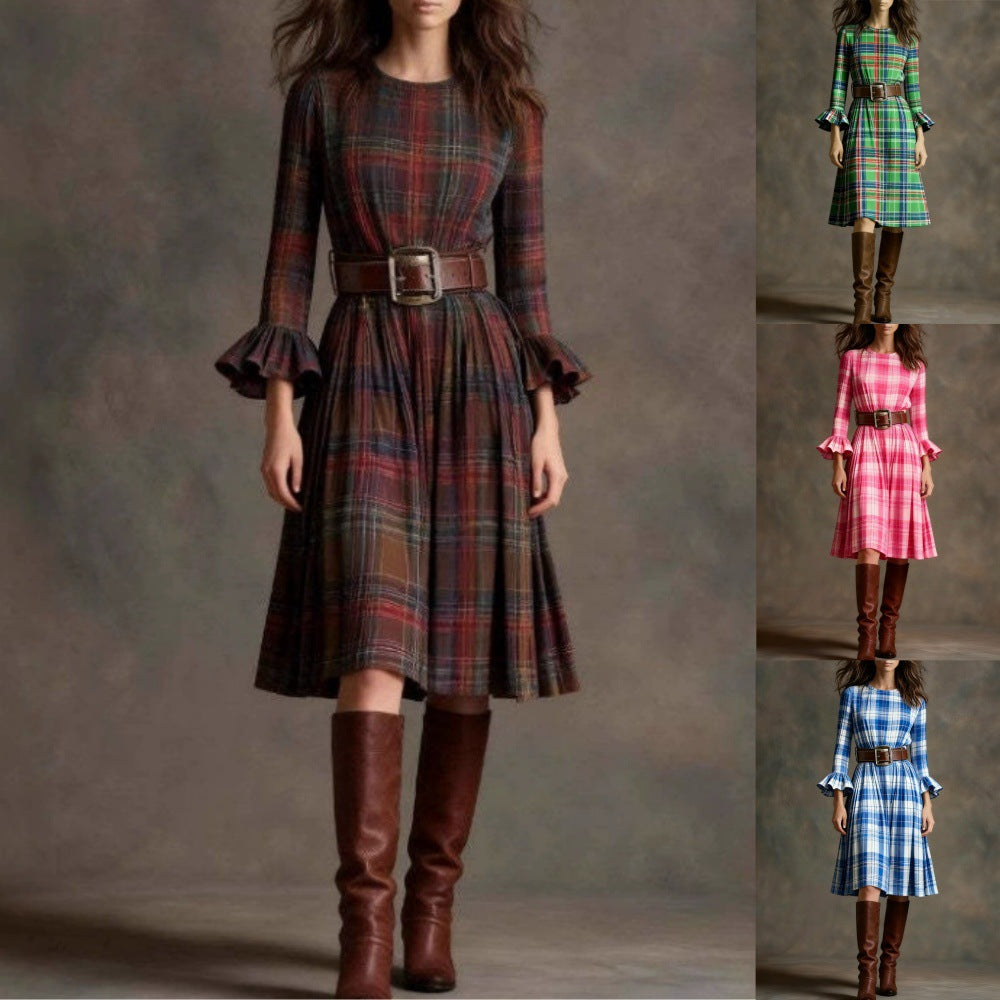 Woman wearing a plaid dress with brown knee-high boots on a gray background by millivan