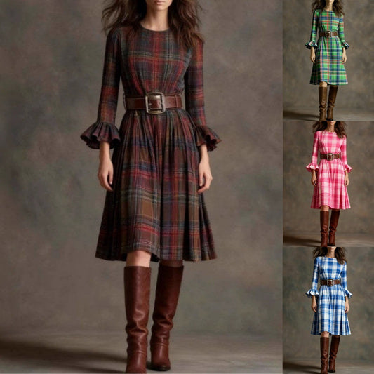 Woman wearing a plaid dress with brown knee-high boots on a gray background by millivan
