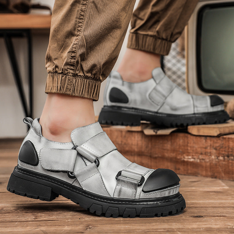 Silver shoes with black soles worn by a person, with a vintage television in the background.