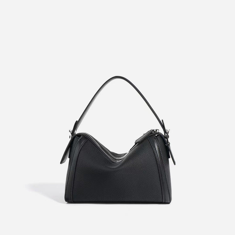 Black handbag on a light gray background